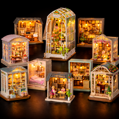 Collection de book nooks miniatures DIY en bois avec éclairage LED, différents univers décoratifs présentés sur fond noir professionnel