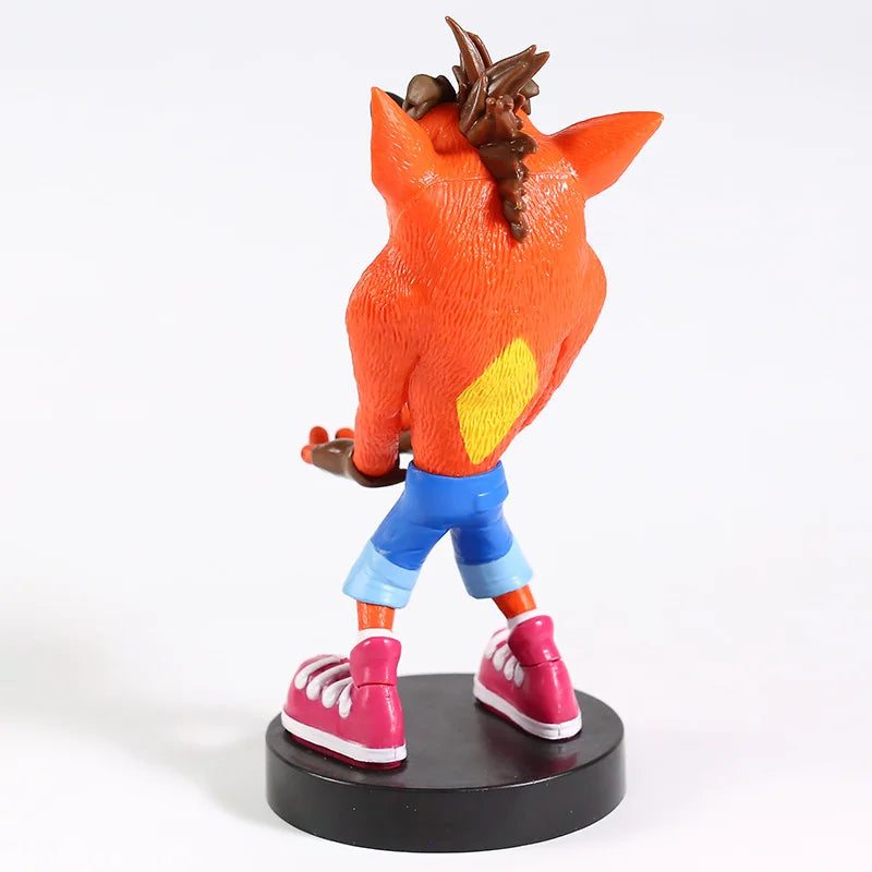Vue arrière de la figurine Crash Bandicoot™ en PVC, bras tendus, sur socle noir. Support déco geek 22 cm compatible manettes et téléphones.