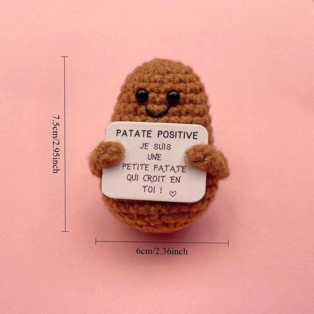 Peluche Patate Positive marron au crochet tenant une pancarte “Je suis une petite patate qui croit en toi”, format mini 7,5 cm.